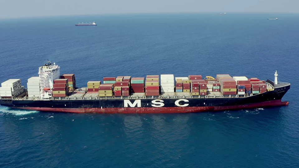 A large container vessel sailing across open water