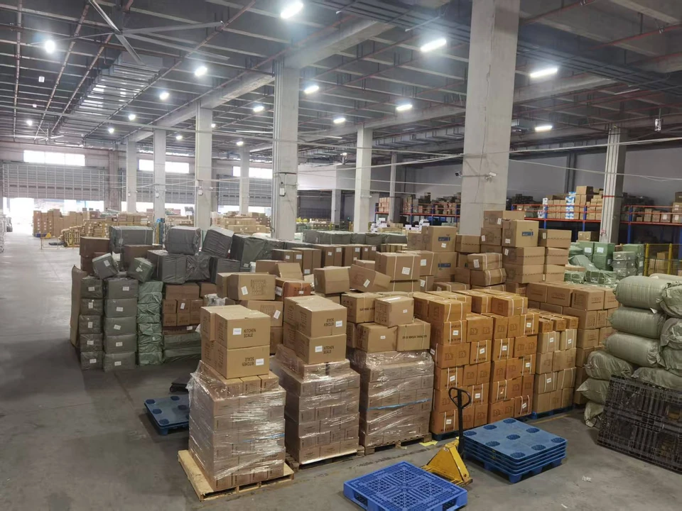Cartons and wrapped cargo organised on pallets in the supplied warehouse photograph